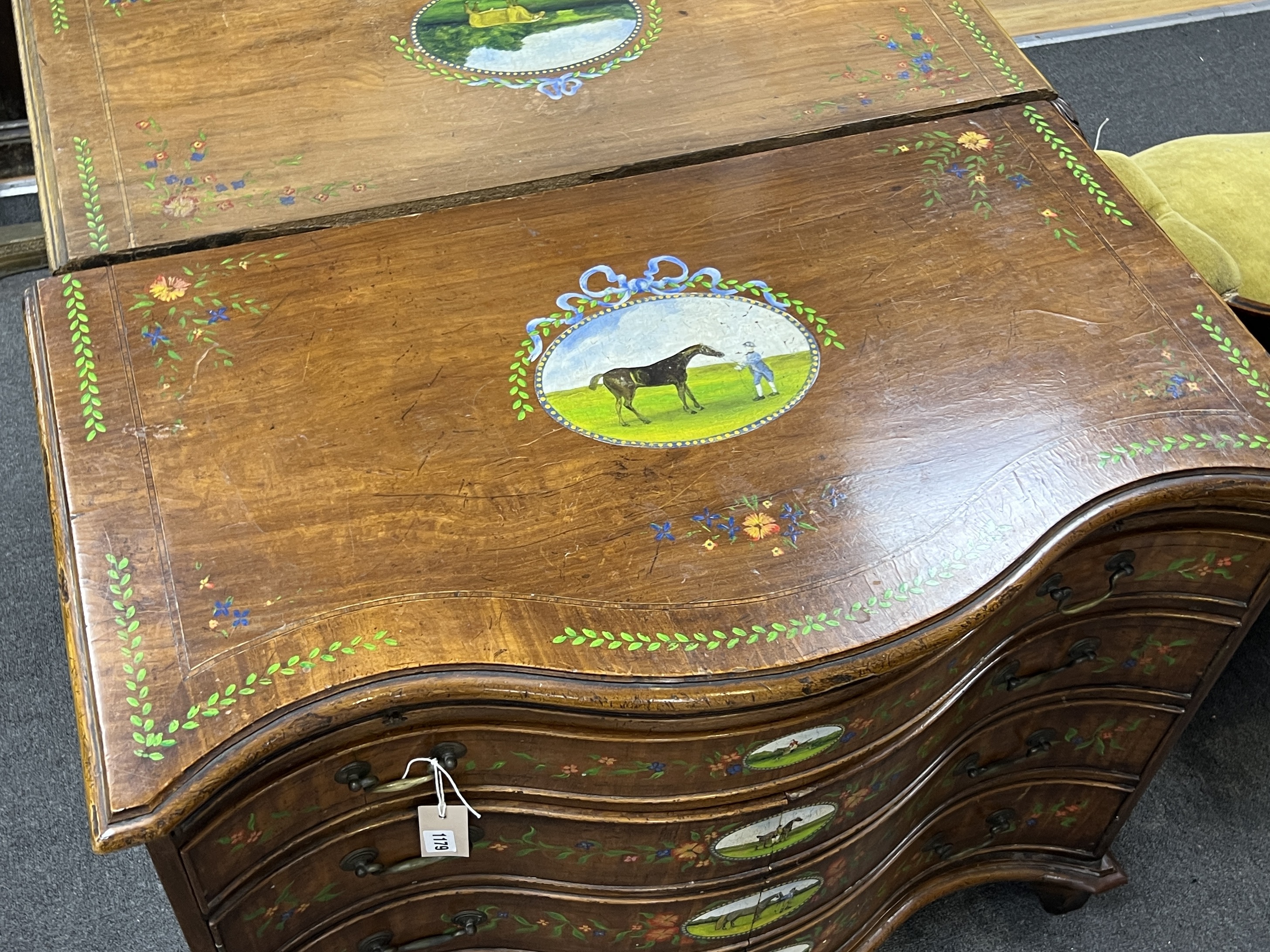 A George III style painted satinwood serpentine chest with part dummy drawer front, width 91cm, depth 48cm, height 75cm